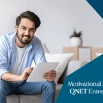 A young QNET entrepreneur smiling while watching motivational movies on his tablet in an indoor setting