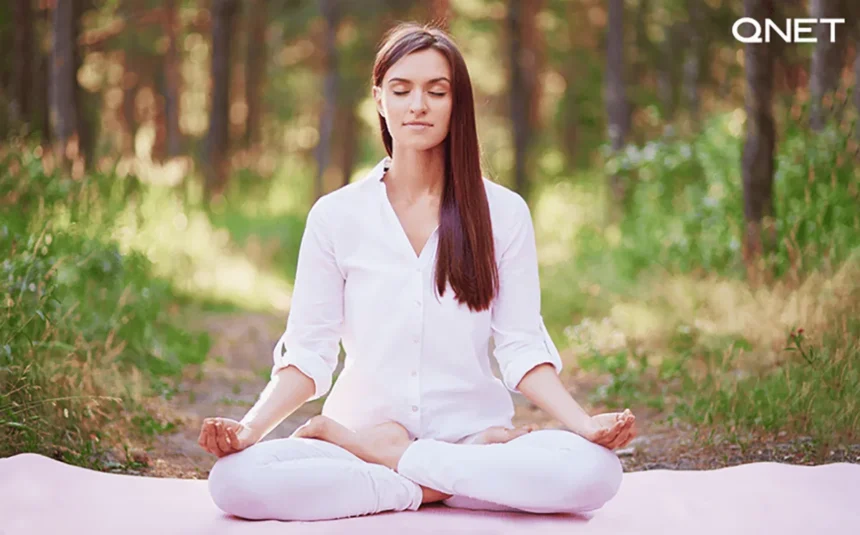 A young woman meditating outdoors