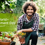A young happy man holding a plant