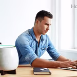 A young man working on his laptop next to Homepure Zayn