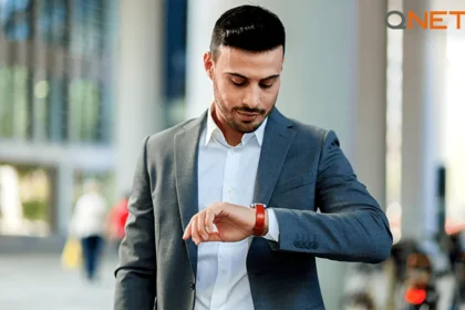 A young man looking at his wrist watch for time