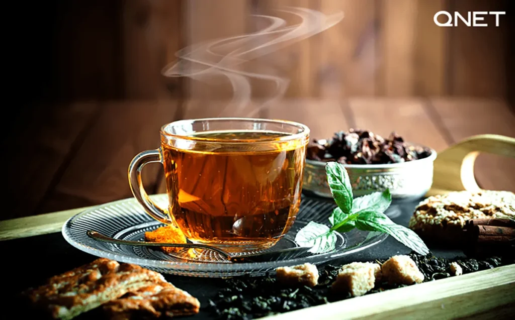 A piping cup of herbal green tea with spices and ingredients