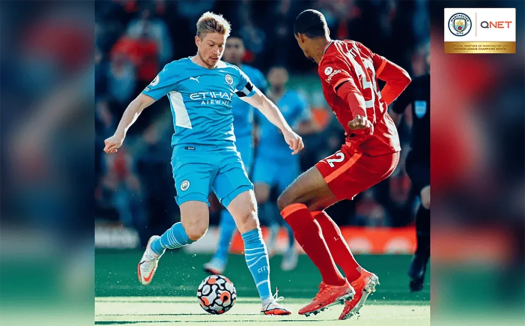 Kevin De Bruyne dribbling the ball past Liverpool players