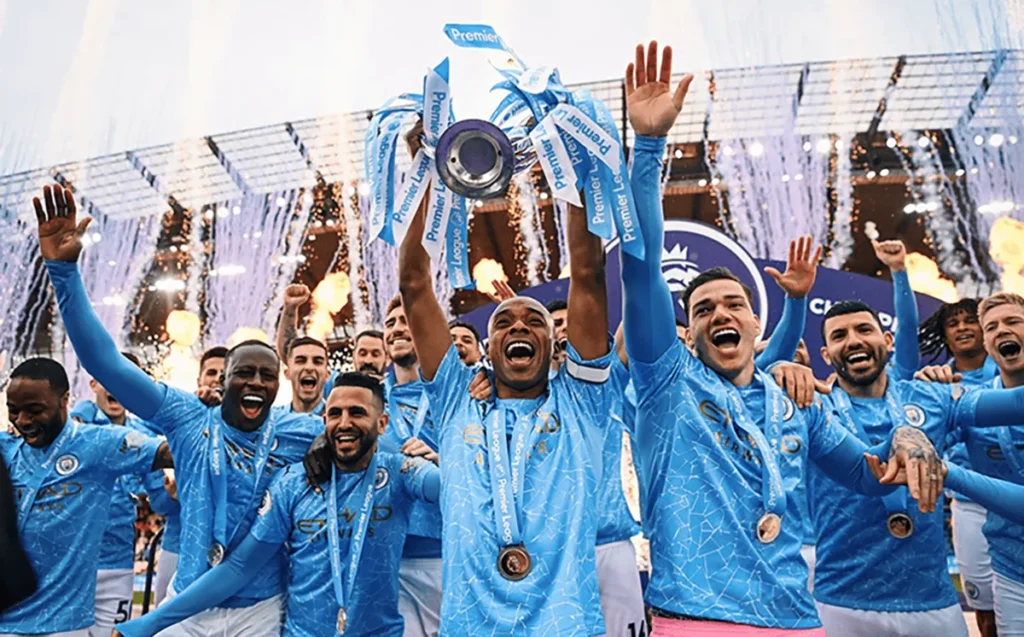 Manchester City players lifting the Premier League trophy after the 2020-21 season