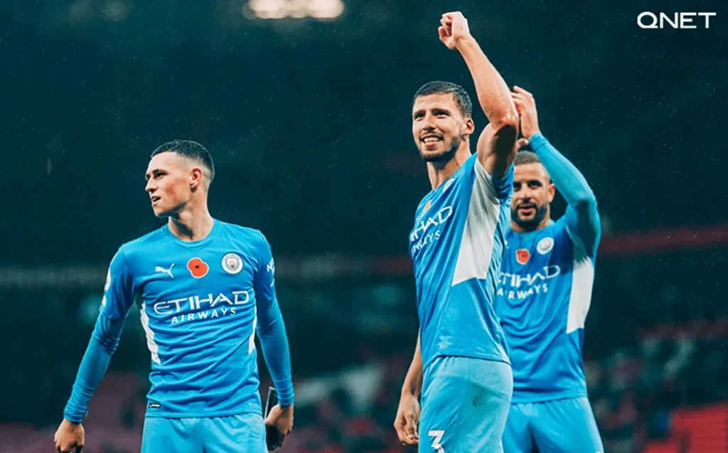 Manchester City’s Ruben Dias, Kyle Walker and Phil Foden celebrate a victory in Premier League 2021-22 