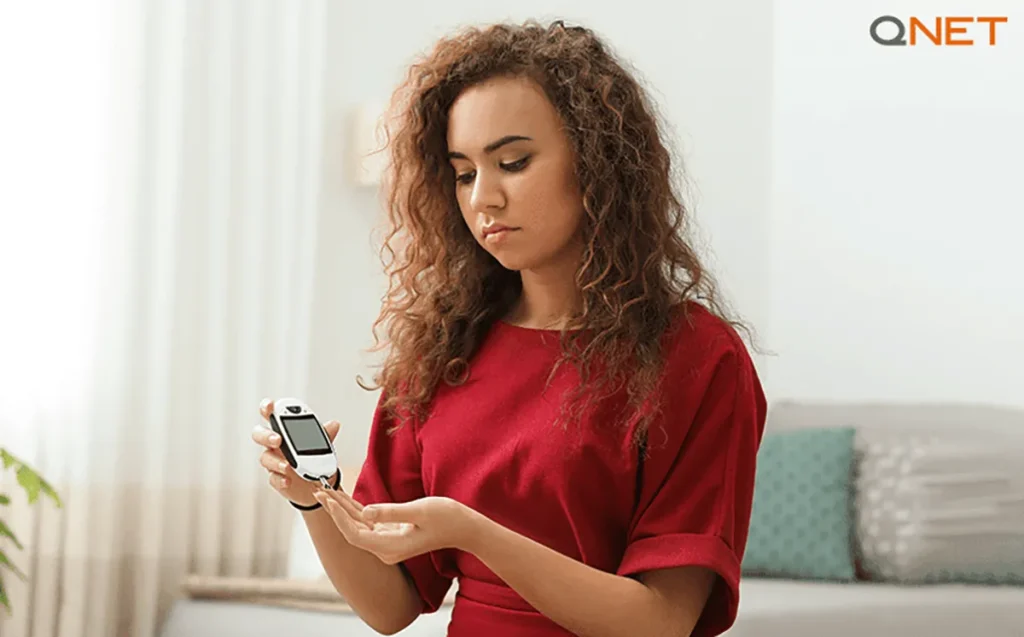 A worried young woman checking her blood sugar levels