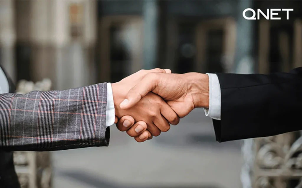 Two businessman shaking hands and making a deal