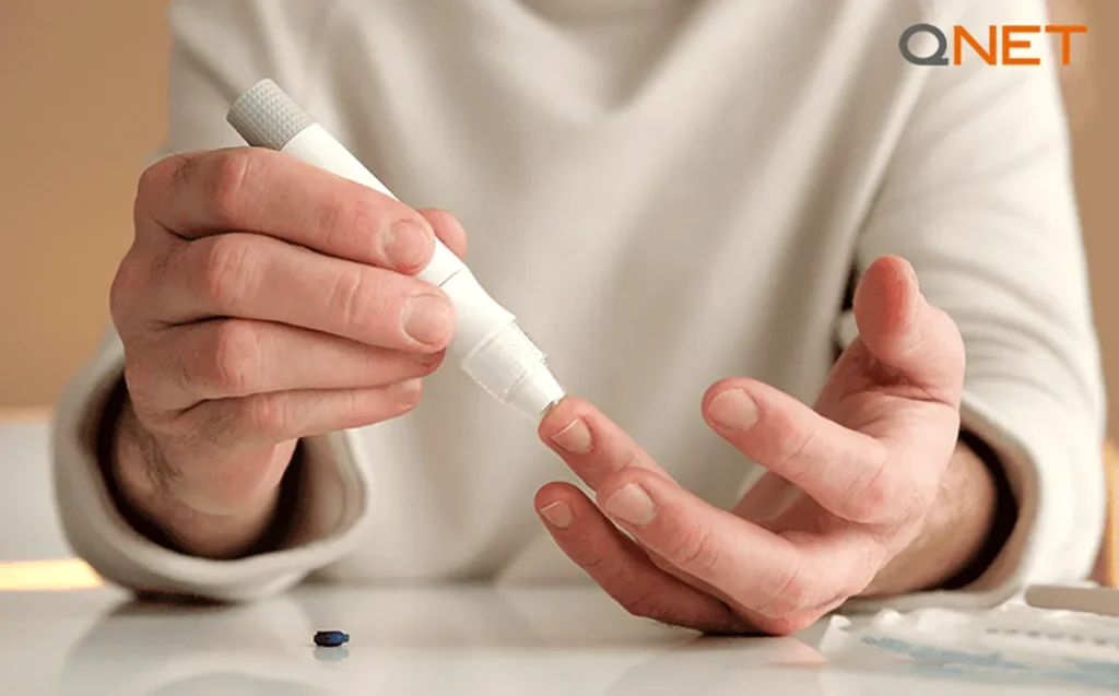 A hand taking a blood sugar test