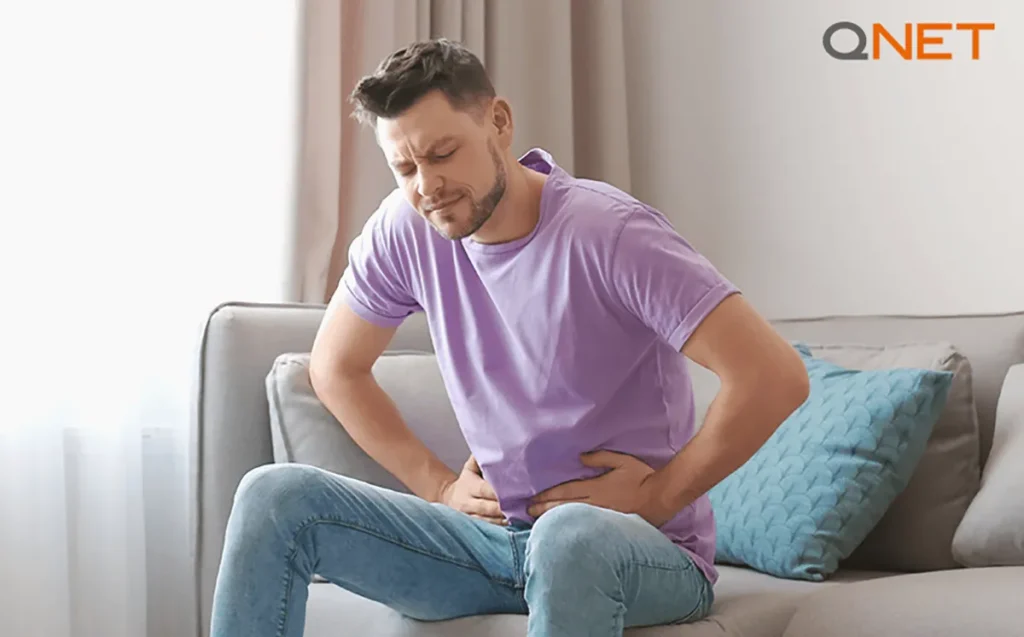 A man holding his aching stomach