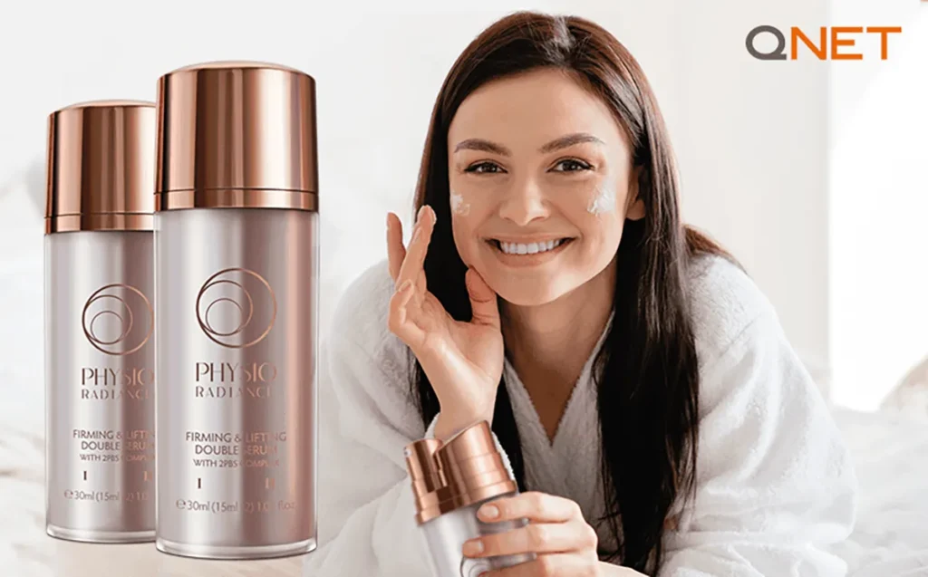 A woman smiling and holding the Physio Radiance Firming and Lifting Double Serum