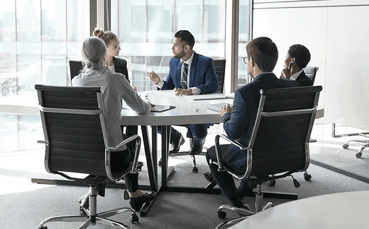 office people sitting at a table meeting