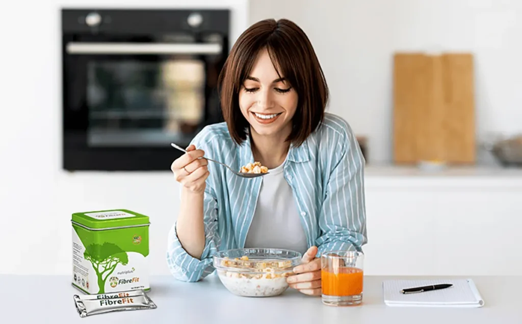 A young woman eating a healthy meal with the addition of Nutriplus FibreFit