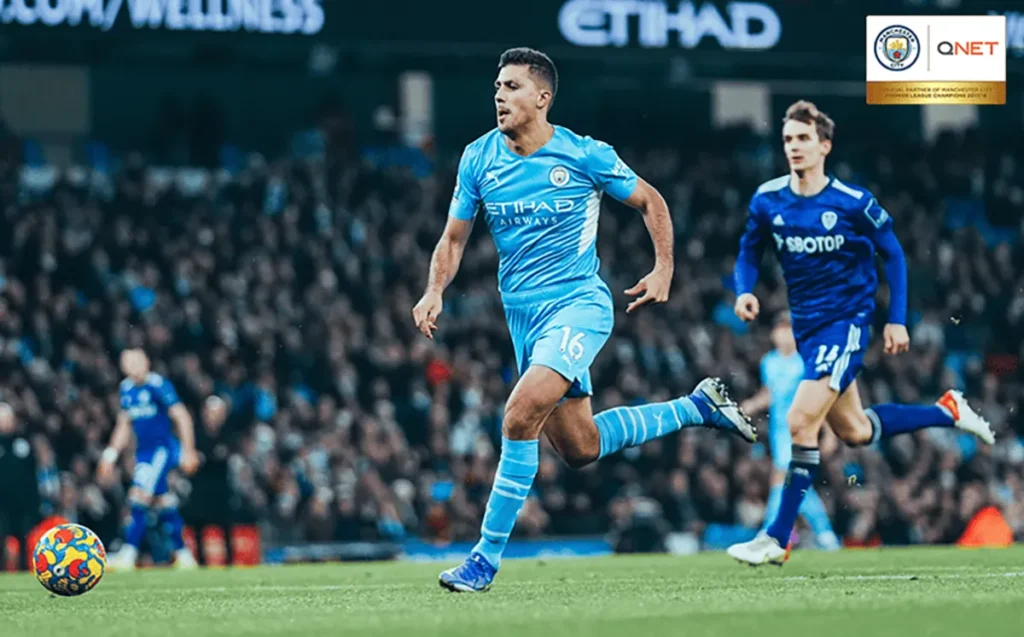 Rodri running with the ball in a game against Leeds United in the Premier League