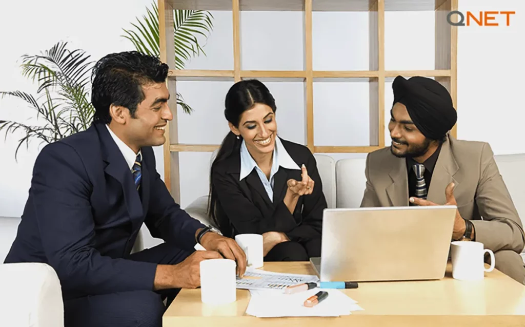 A business meeting between three direct sellers at an office