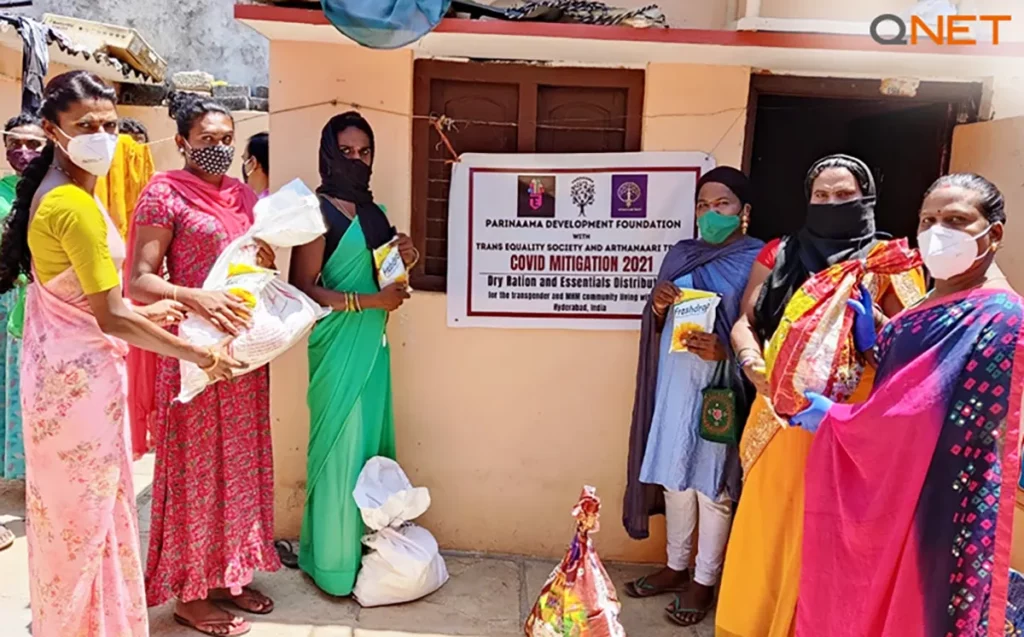 A group of women standing with essentials provided by Parinaama Development Foundation with the help of RYTHM Foundation.