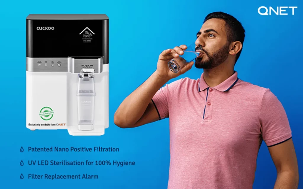 A young Indian man drinking water with MyHomePlus DELIGHT – Alkaline Nano Water Purifier in the frame