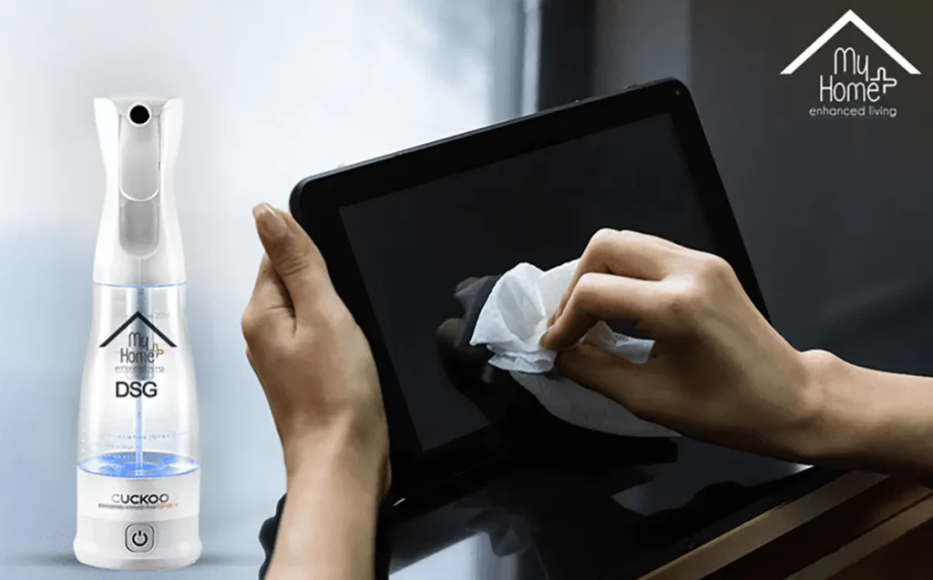 A young Indian woman cleaning her tablet with a white cloth with MyHomePlus DSG in the frame