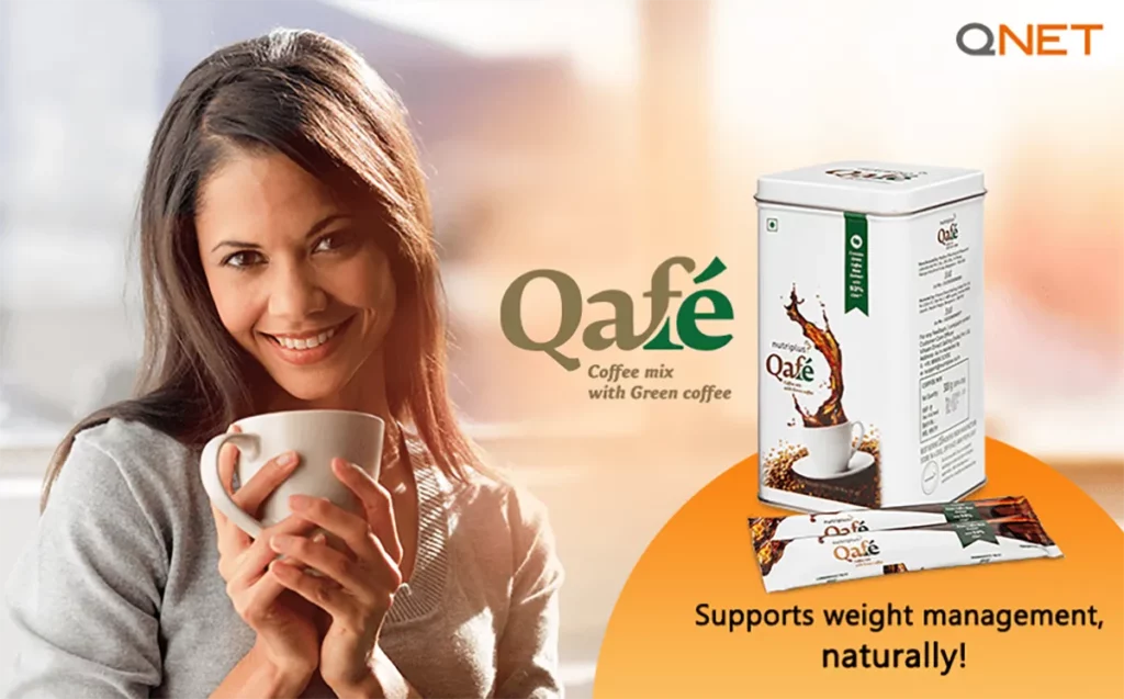 A young Indian woman drinking QNET’s Nutriplus Qafé green coffee in her kitchen