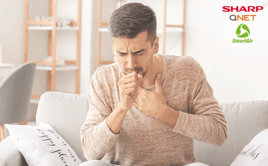 A young man coughing due to breathing problems
