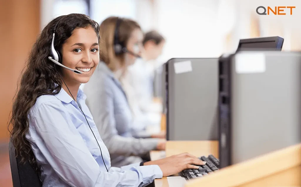 A young woman answering a call at QNET’s Global Support Centre
