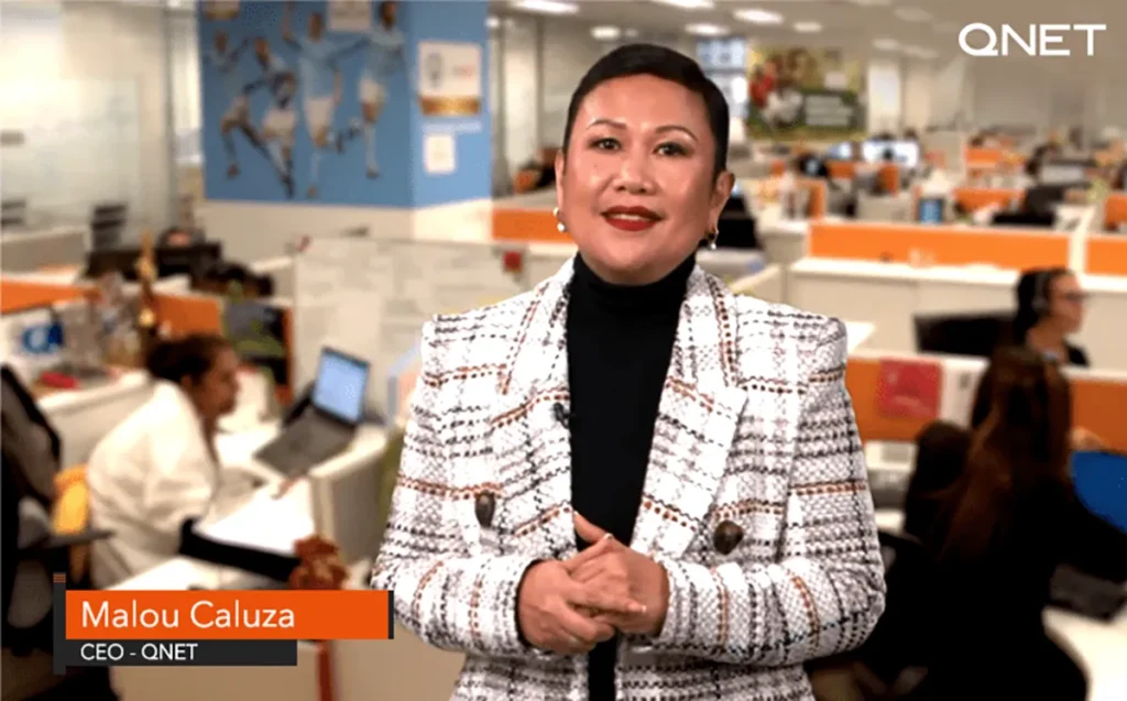 CEO of QNET, Malou Caluza, standing in the QNET office during VCC 2021