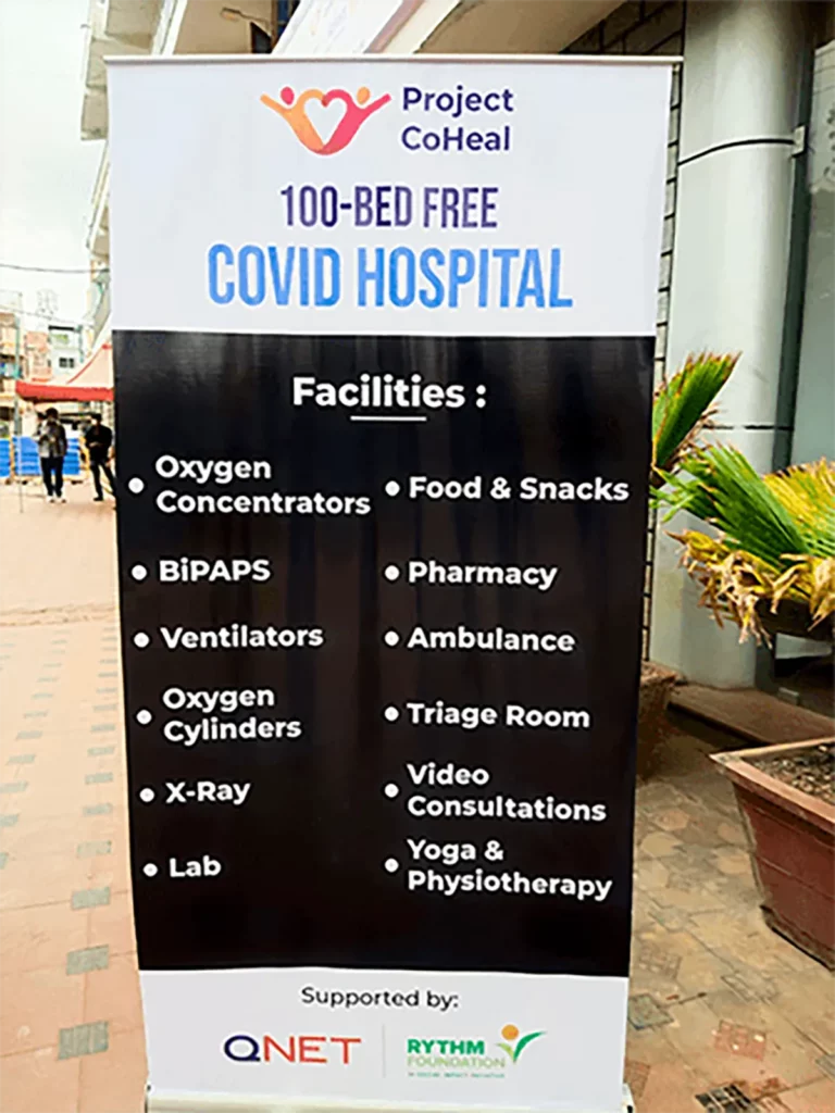Facilities of Project CoHeal by QNET India for COVID-19 patients highlighted by a standee.