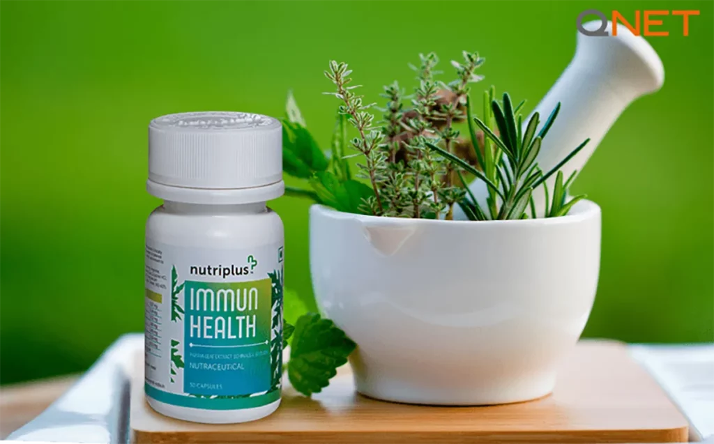 Fresh herbs in a mortar with Nutriplus ImmunHealth on the table.