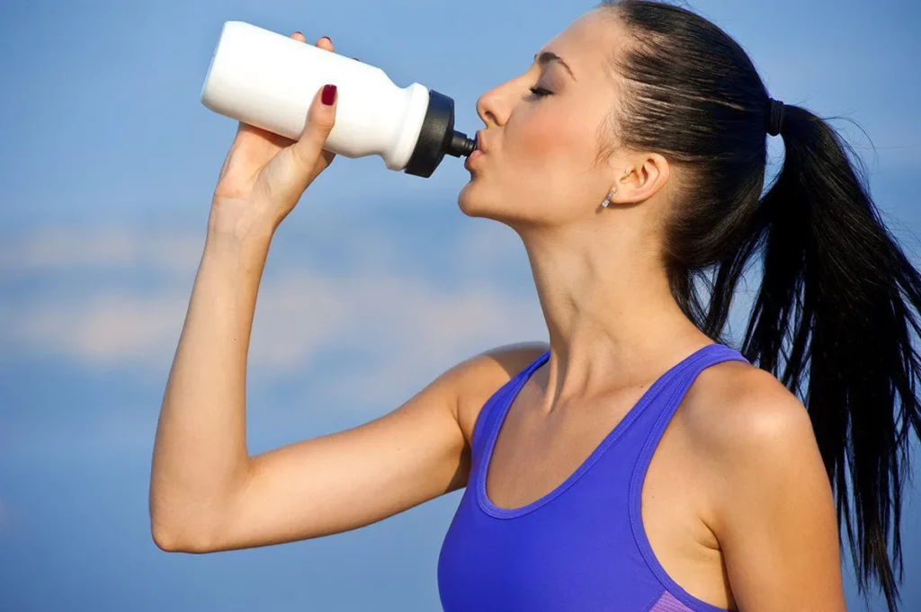 Drinking Water: Girl drinking water after exercising