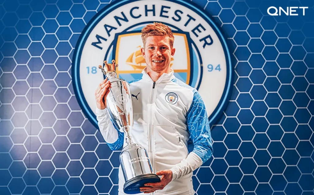 Kevin De Bruyne holding the Premier League Player of the Season trophy in the 20202021 season