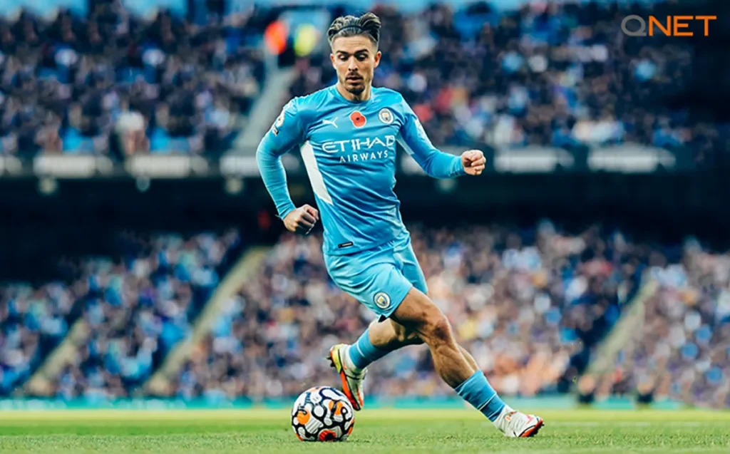 Manchester City player Jack Grealish dribbles the ball during a match in the Premier League