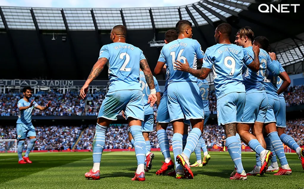 Manchester City players celebrate a goal in the Premier League