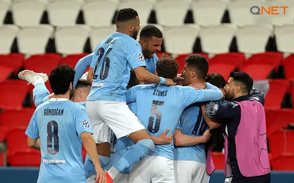Manchester City players celebrating and motivating each other during a game