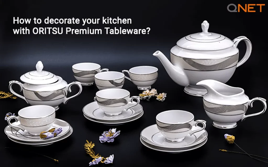 Oritsu tableware with flower decoration on the table and ‘how to decorate your kitchen’ in the frame