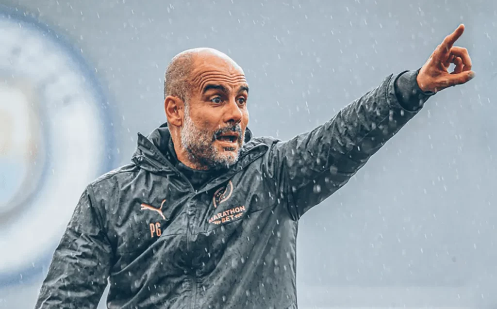 Pep Guardiola giving instructions to his team during a match.