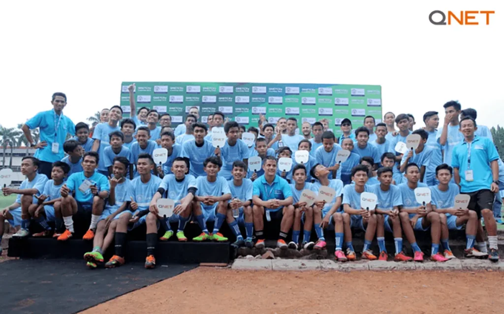 QNET-ManCity conduct Football Coaching Clinic in Indonesia for underprivileged youth from Rusun as they assemble for a group photo
