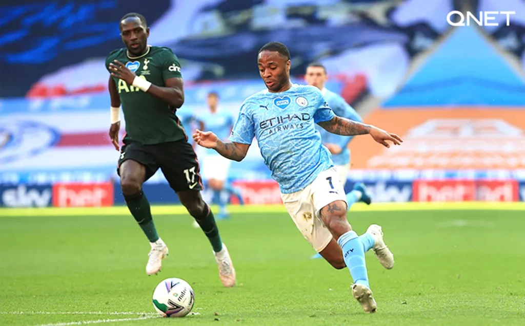Raheem Sterling dribbling the ball during a match against Tottenham Hotspur in the 20202021 season