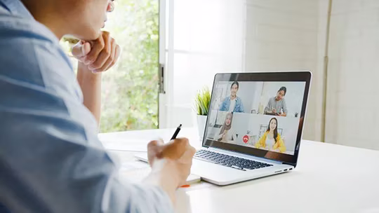 young man discussing with laptop meeting call