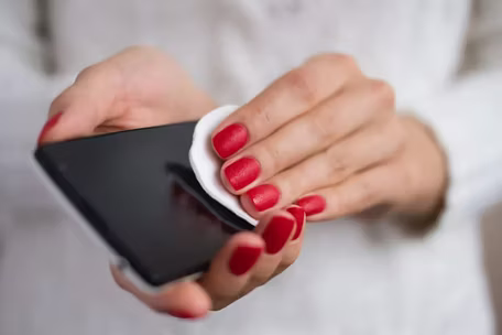 woman cleaning her phone screen