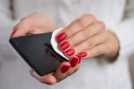 woman cleaning her phone screen