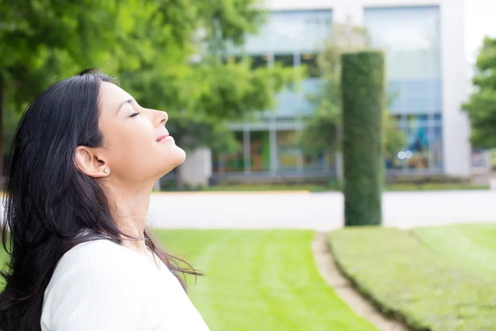 complete wellbeing: girl breathing in fresh air