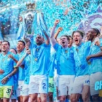 Manchester City squad celebrates their unprecedented fourth consecutive Premier League championship Four-In-A-Row
